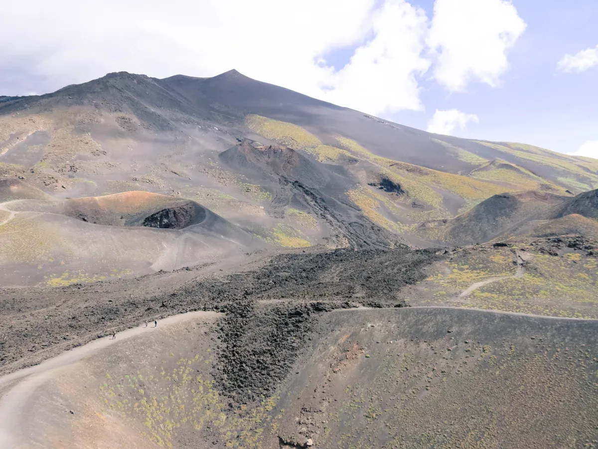 Cinder cones and black lava fields on Mount Etna climbed on a 3,000 meter summit excursion, Sicily